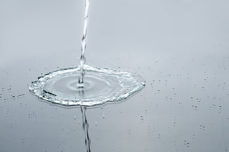 splashing water on a smooth surfaceの写真素材