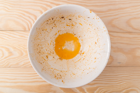 dirty bowl on a wooden backgroundの写真素材