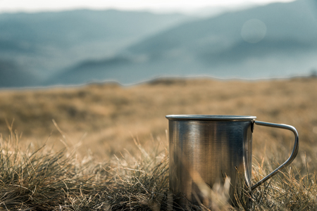 metal cups on a background of mountainsの写真素材