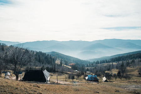 several old houses on a background of mountainsの写真素材
