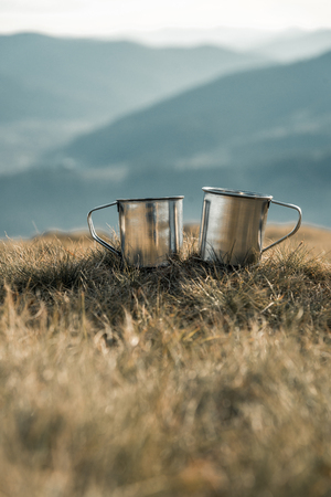 metal cups on a background of mountainsの写真素材