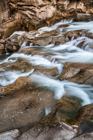 rocky river shrouded in water for the whole frameの写真素材
