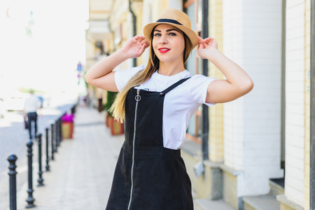 young beautiful girl in overalls and a hatの写真素材