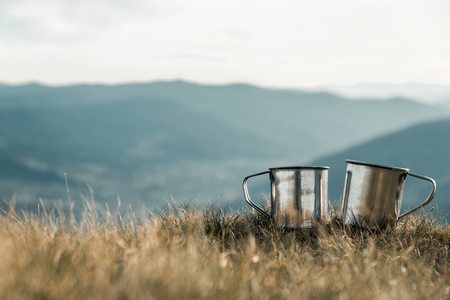 metal cups on a background of mountainsの写真素材