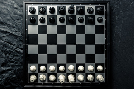 Chess board with black and white chess facing each other. Horizontal frame