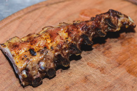 a large piece of fried meat on a wooden board. Horizontal frame