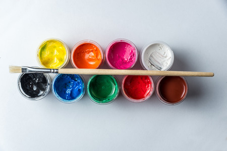 small cans with colorful gouache paints and tassels for the whole frame. Horizontal frameの写真素材