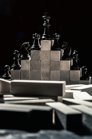Career ladder. chess from checkers to the king stand on wooden steps. Vertical frameの写真素材