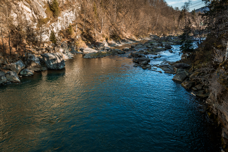 view of the river or lake surrounded by mountains and stonesの写真素材