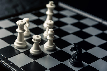 Chess board. The black horse threatens the opponent's white chess. Horizontal frame