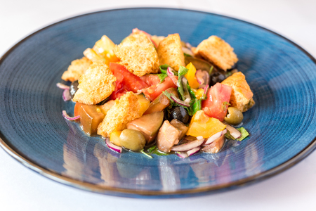 vegetarian salad of vegetables, herbs and crackers, on a blue plate. Horizontal frameの写真素材