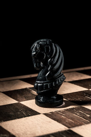 Chess board. Beautiful handmade black horse. Vertical frameの写真素材