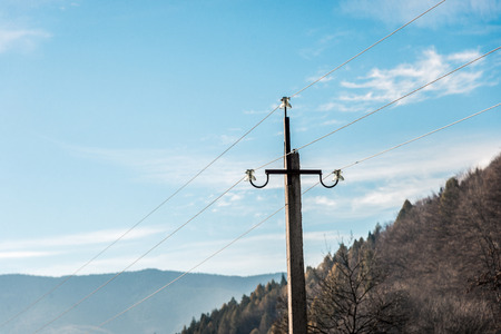 Blue beautiful sky over the mountains and a power pole in the foreground. Horizontal frameの写真素材