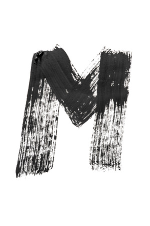 The English alphabet, the letter "M" is written in black paint on a white isolated background. Vertical frameの写真素材