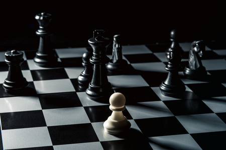 Chess board. White checker threatens the black chess opponent. Horizontal frameの写真素材