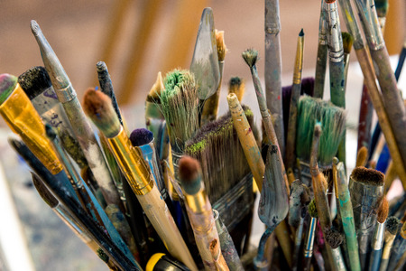 Close up of a lot of painter's brush in paint. Horizontal frameの写真素材