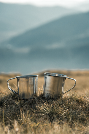metal cups on a background of mountainsの写真素材