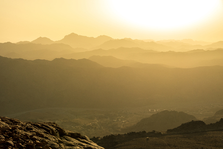 View of the sunrise on the bare mountain from the top of the mountain. Horizontal frameの写真素材