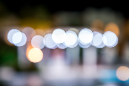 blurred night background, colored lights, water and buildings in defocus. Horizontal frame