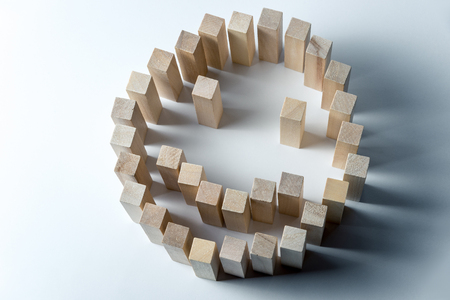 a large smiley made of wooden cubes, as a symbol of happiness, success and accomplished task, on an uneven white backgroundの写真素材