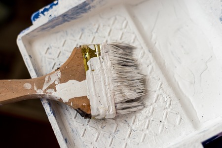 dirty brush with white paint is on the standの写真素材