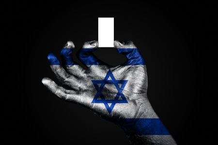 hand with a painted flag Israel holding a small white sheet with space for an inscription, mock up. Horizontal frameの写真素材