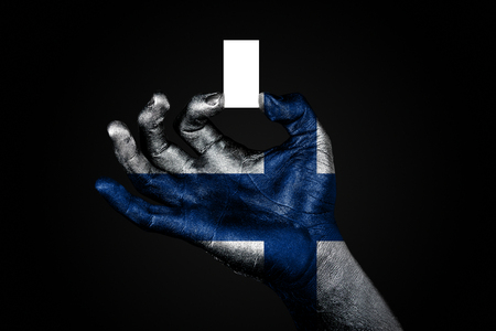 hand with a painted flag Finland holding a small white sheet with space for an inscription, mock up. Horizontal frameの写真素材