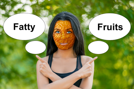 young girl with orange peel skin, bad skin sign, shows the words "fatty" and "fruit". Horizontal frameの写真素材