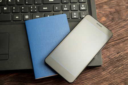 preparation for travel, passports, phone and laptop are on a wooden background. Horizontal frameの写真素材
