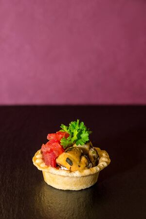 tasty canapes with seafood on a red background.の写真素材