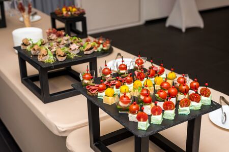 Assorted meat, vegetable, cheese canapes on skewers for the whole frame.の写真素材