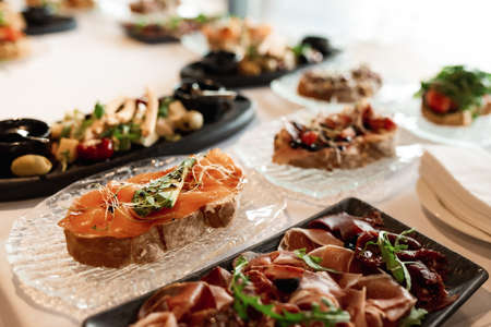 bruschetta square set top view. Brushetta set for wine. Variety of small sandwiches with prosciutto,...