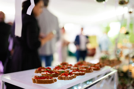 Bruschetta with feta cheese, roasted red sweet peppers and basil on a light wooden background. selective focusの写真素材