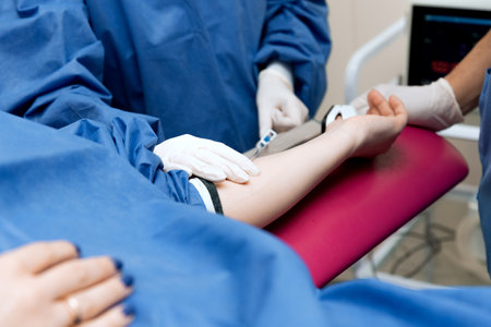 medical procedure, the doctor takes blood from the patient's vein, close-upの写真素材