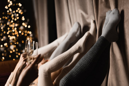 legs of four beautiful girls in stockings lie with champagne close-upの写真素材