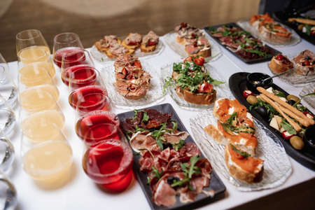 bruschetta square set top view. Brushetta set for wine. Variety of small sandwiches with prosciutto, tomatoes, cheese, herbsの写真素材