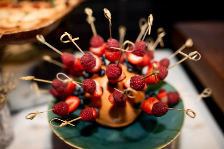 many berry canapes with raspberries, strawberries and currantsの写真素材