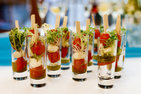 Cocktail party with variety of desserts and food decorated in small shot glassesの写真素材