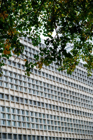 Glass gray square Windows of modern city business building skyscraper. Glass balconies in the building. Modern apartment buildings in new neighborhood. Windows of a building, textureの写真素材