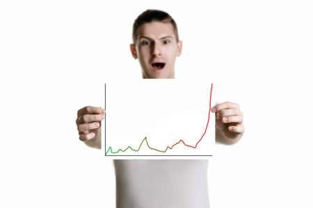 young man shows graph on a piece of paperの写真素材