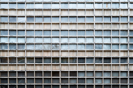 Glass gray square Windows of modern city business building skyscraper. Glass balconies in the...