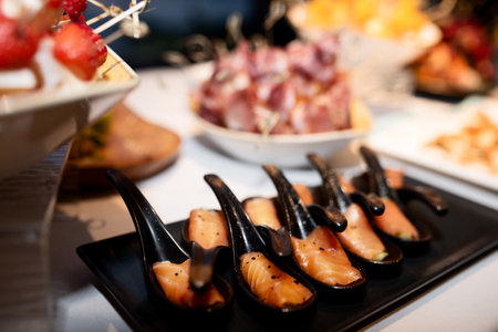 delicacy, salmon meat on black teaspoonsの写真素材