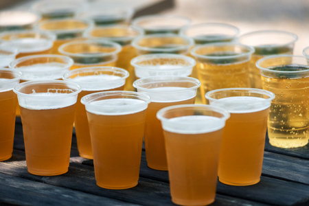 Bar counter full of beer in plastic glasses.の写真素材
