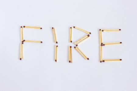 The inscription from the matches is fire. The word is laid out of the wooden matches.の写真素材