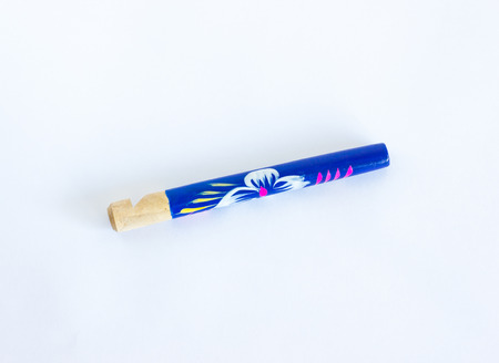 Woody whistle close-up. Vintage painted whistle made from bamboo closeup.の写真素材