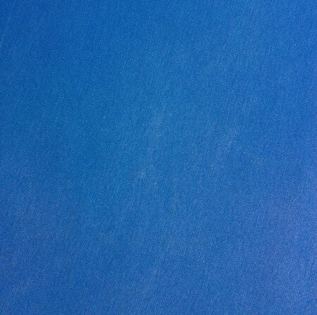 Background of blue fabric. Texture of a blue worn cloth.の写真素材