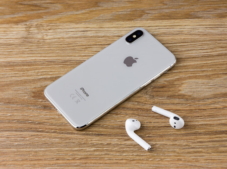 Rostov-on-Don, Russia - December 12, 2017: The Iphone 10 lies on the wooden table next to the...