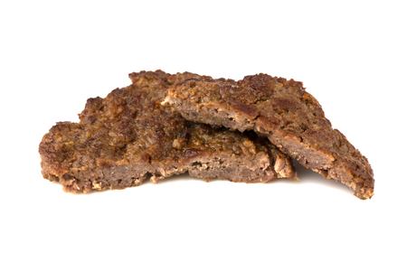 Fried cutlet isolated on white background. Fried beef cutlet for burger cut into two pieces.の写真素材
