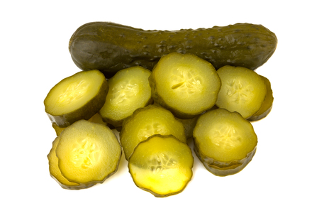 Marinated cucumber isolated on white background. One whole pickled cucumber and a few chopped cucumber slices on a white background.の写真素材