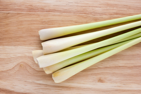 Lemongrass close-up on a wooden table. Fresh stems of lemongrass on a wooden surface.の写真素材